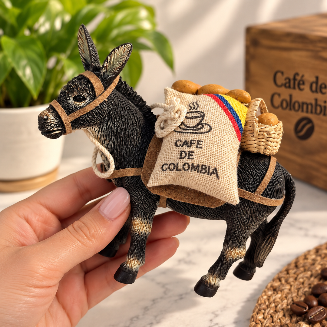 Hand holding Colombian coffee donkey figurine showing collectible size
