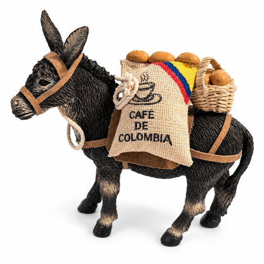 Handcrafted Café de Colombia donkey figurine on white background