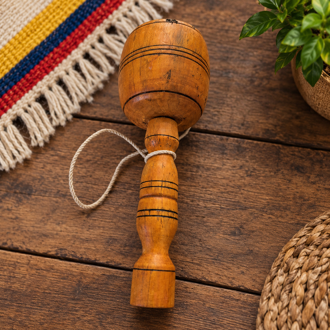 Traditional Colombian balero game displayed on a rustic artisan table