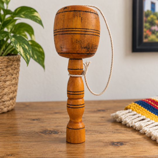 Traditional Colombian balero shown upright to illustrate its approximate 19 cm size