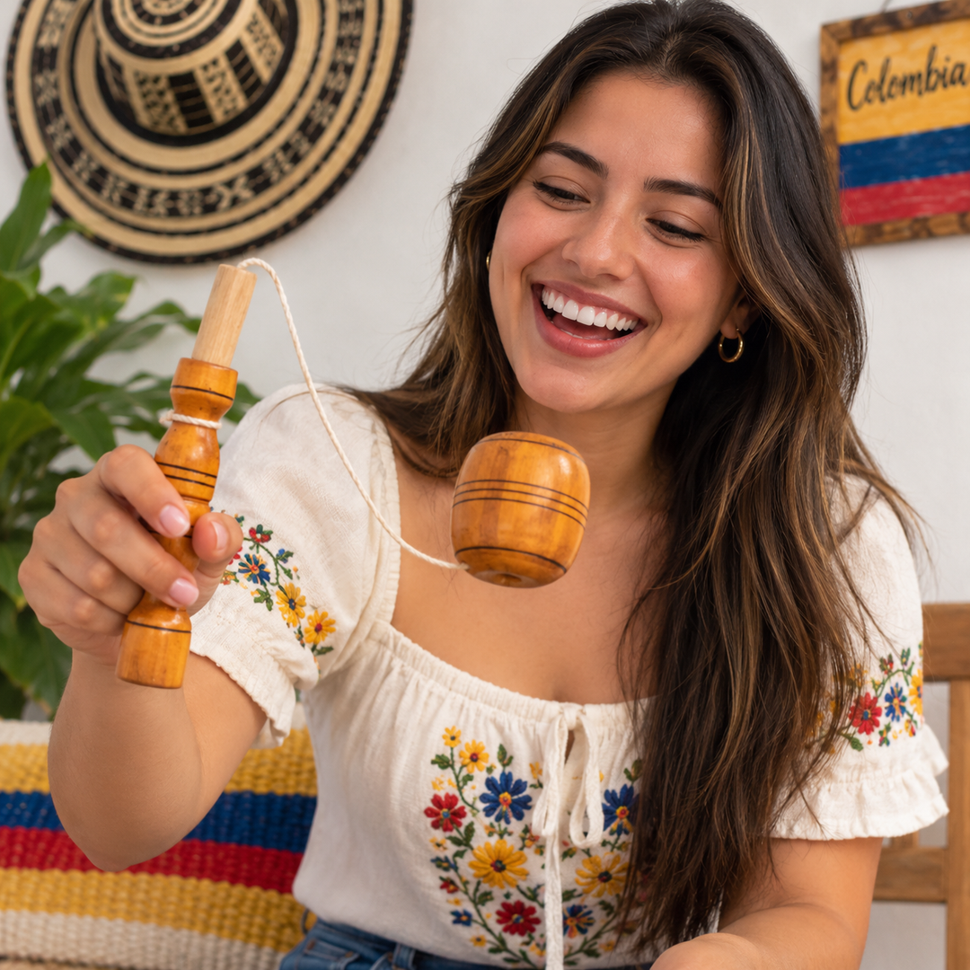 Young woman smiling while playing with a traditional Colombian balero