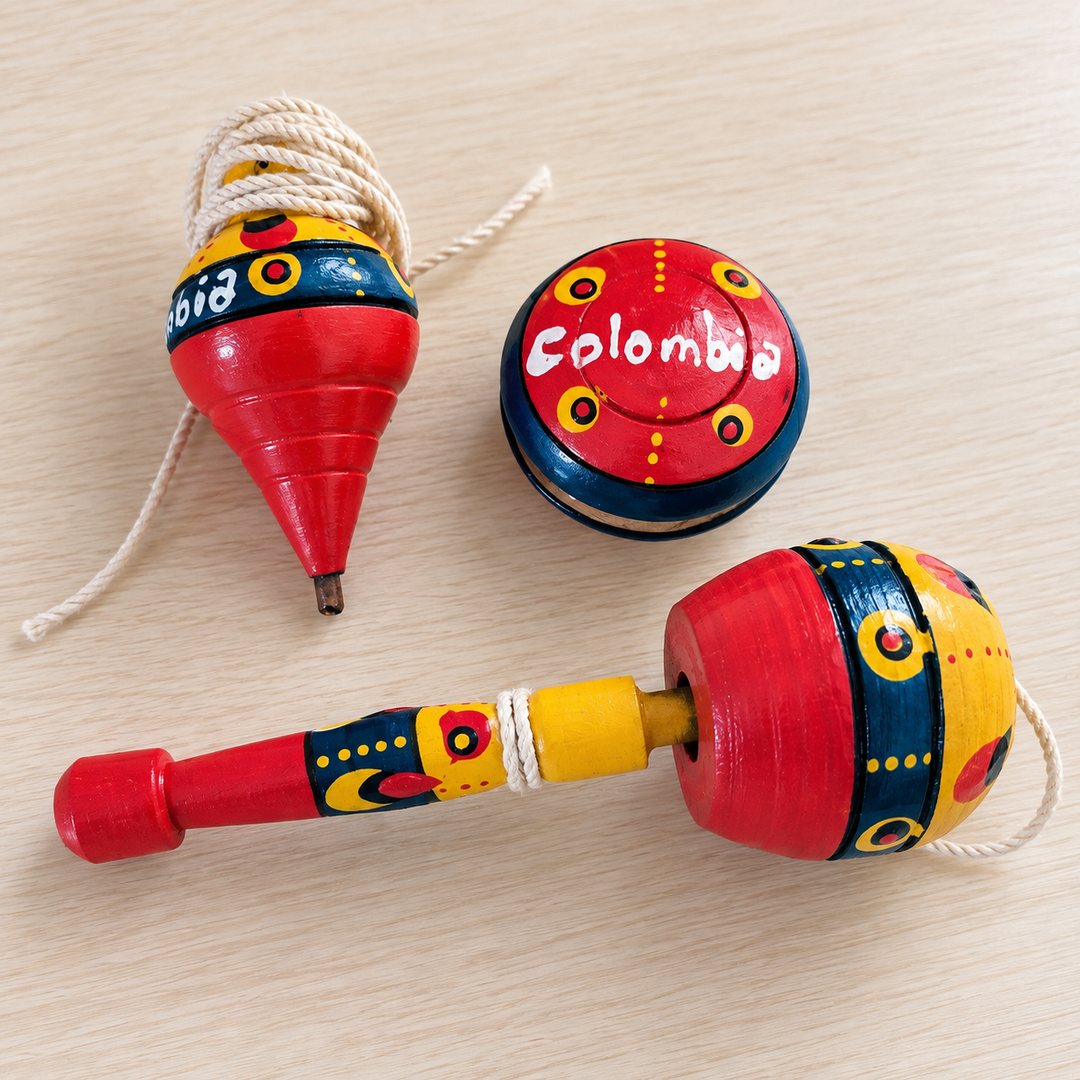 Colombian traditional coca, trompo and yoyo set arranged together on a light tabletop