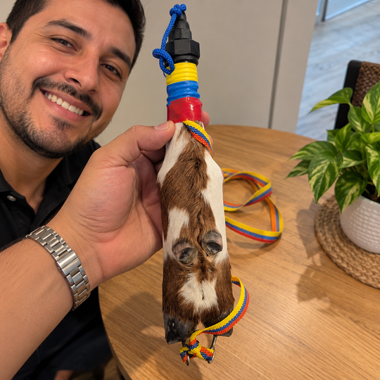 Smiling man holding handcrafted cowhide hoof bottle