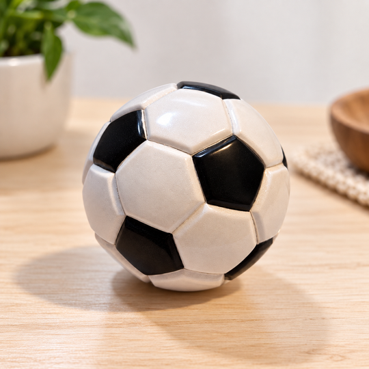Black and white 1974 collectible soccer ball handmade in Mongui, Boyaca, Colombia on a light table