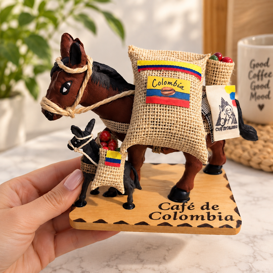 Hand holding Colombian coffee mule figurine showing collectible size